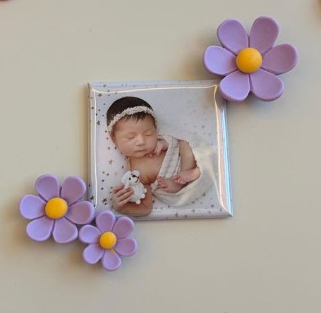A Mero Magnets photo magnet of a sleeping baby, surrounded by lavender flower magnets
